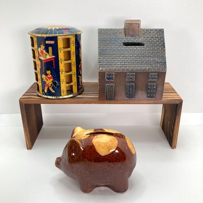 LOT 531: Vintage Coin Bank Collection - Tin Litho Rotary Sorter, Ceramic Cabin, Tin Litho Rotary Sorter, Rexair Vacuum and Piggy Bank
