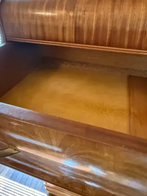 Sale Photo Thumbnail #205: Open drawer of an antique wood dresser displaying clean interior construction and rich grain finish.
