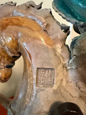 Sale Photo Thumbnail #150: Close-up detail of a glazed ceramic Tang dynasty style horse statue, showing an impressed seal mark near the neck.