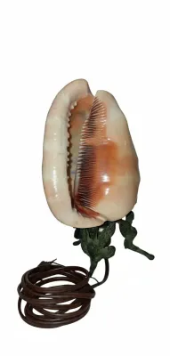 Sale Photo Thumbnail #73: Vintage seashell accent lamp mounted on an ornate bronzed tripod base featuring cherub or winged figures.
