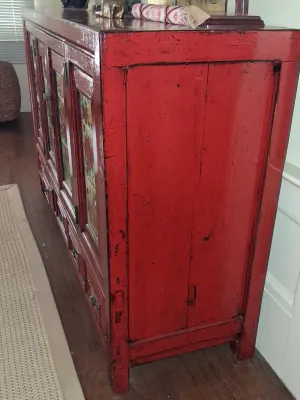 Sale Photo Thumbnail #177: Chinese red lacquered sideboard featuring framed floral front panels, lower drawers, and aged distressed finish.