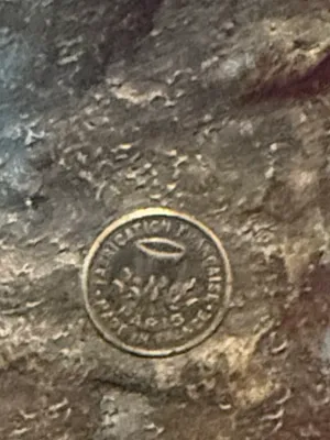 Sale Photo Thumbnail #136: Close-up detail of a circular foundry mark reading 'Fabrication Francaise Paris Made in France' stamped onto a metal sculpture.