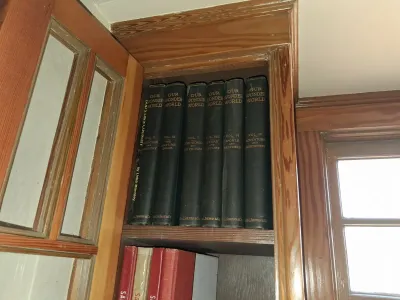 Sale Photo Thumbnail #107: Vintage 'Our Wonder World' hardcover encyclopedia book set stored in a wooden cabinet shelf.