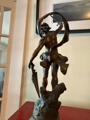 Sale Photo Thumbnail #138: Bronze sculpture of a classical male warrior figure holding a sword and shield, featuring dynamic flowing drapery.