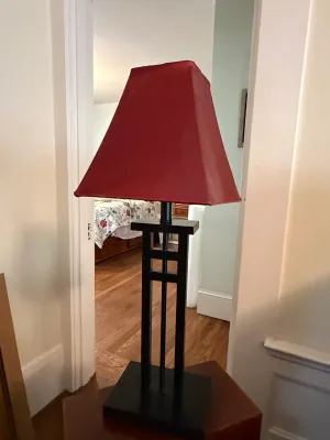 Sale Photo Thumbnail #189: Modern Mission-style table lamp featuring a dark wood, open geometric base and a tapered red fabric shade.