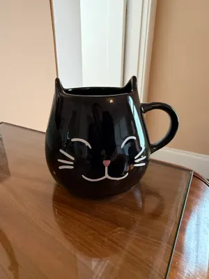 Sale Photo Thumbnail #253: Black ceramic cat-shaped mug featuring 3D ears and a painted smiling face design.