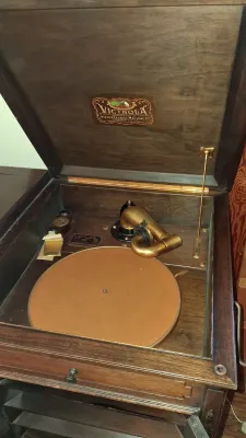 Sale Photo Thumbnail #15: Antique Victor Talking Machine Co. Victrola phonograph with dark wood cabinet and brass tonearm assembly.