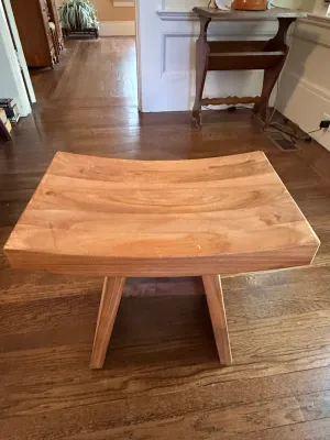 Sale Photo Thumbnail #168: Mid-century modern wooden stool featuring a curved, contoured seat and angled legs.