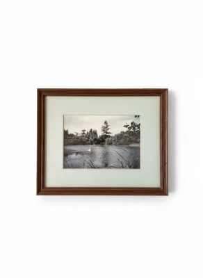Sale Photo Thumbnail #295: Framed black-and-white landscape photograph depicting a quiet lake scene, housed in a wide off-white mat and a dark wood frame.