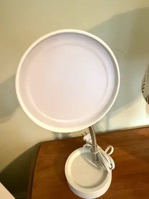Sale Photo Thumbnail #409: Modern white tabletop illuminated makeup mirror featuring a flexible gooseneck neck, circular tray base, and power cord.