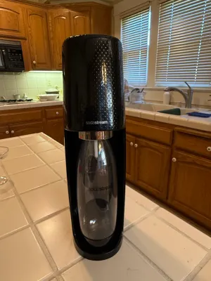 Sale Photo Thumbnail #458: Black SodaStream Fizzi sparkling water maker, complete with a reusable carbonating bottle.