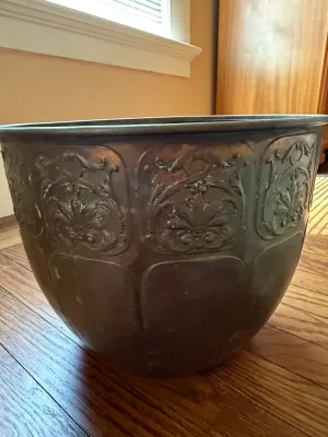 Sale Photo Thumbnail #200: Large antique embossed metal planter or cauldron featuring ornate scrollwork relief around the upper rim.