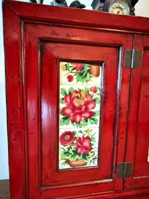 Sale Photo Thumbnail #176: Vintage red-lacquered wooden cabinet featuring inset hand-painted floral ceramic tiles on the door panel.