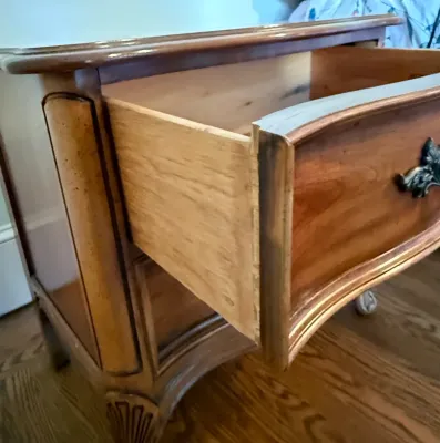 Sale Photo Thumbnail #398: French Provincial style nightstand or end table with a serpentine front and open drawer showcasing solid wood dovetail construction.