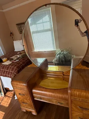 Sale Photo Thumbnail #252: Art Deco waterfall vanity with a large round mirror and figured wood veneer, circa 1930s.