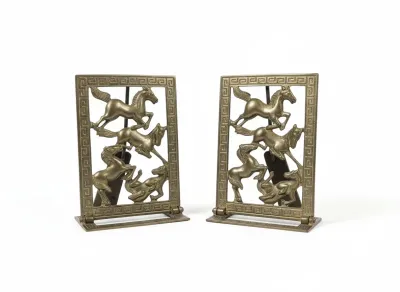 Sale Photo Thumbnail #21: Pair of brass bookends featuring an openwork design of running horses framed by a Greek key border.