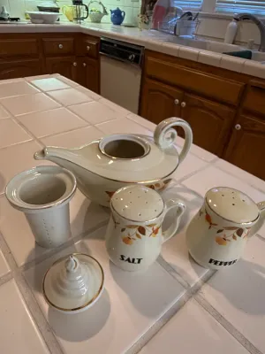Sale Photo Thumbnail #443: Vintage Hall Autumn Leaf ceramic Aladdin tea pot with strainer insert and lid, accompanied by matching salt and pepper shakers.