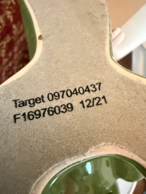Sale Photo Thumbnail #276: Bottom base of a green ceramic Target home decor item, showing felt padding and printed identification numbers dated 12/21.