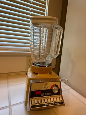 Sale Photo Thumbnail #470: Vintage Osterizer Imperial Pulse-Matic 10-speed blender in harvest gold with a glass pitcher.