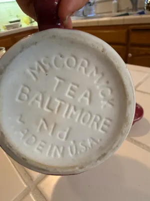 Sale Photo Thumbnail #466: Bottom detail of a vintage McCormick Tea glazed ceramic mug, featuring raised maker's mark reading 'McCORMICK TEA BALTIMORE Md MADE IN U.S.A.'