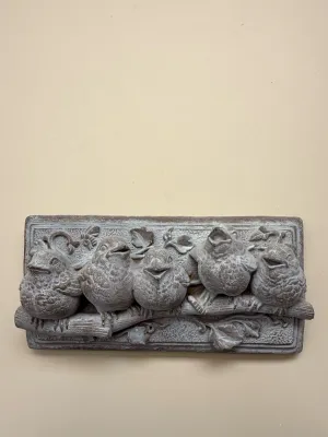 Sale Photo Thumbnail #419: Rustic cast stone or resin wall plaque depicting five songbirds perched on a branch, featuring a weathered grey finish.