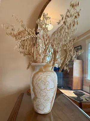 Sale Photo Thumbnail #277: Polished onyx or banded calcite urn-shaped vase filled with decorative dried wheat and oat stalks.