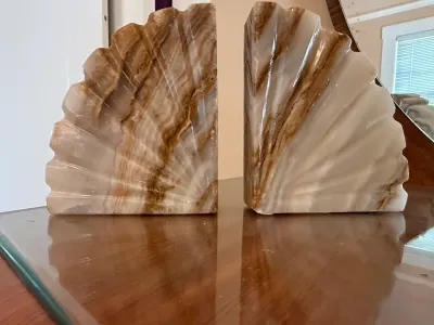 Sale Photo Thumbnail #235: Pair of vintage carved onyx or alabaster shell-form bookends with natural cream and brown banding.