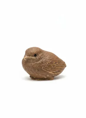 Sale Photo Thumbnail #53: Small molded brown resin or ceramic bird figurine with textured feather details and black bead eyes.