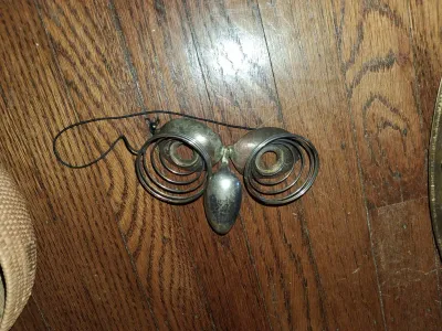 Sale Photo Thumbnail #80: Whimsical folk art owl mask crafted from repurposed silverplate spoons and wire springs, featuring an elastic band for wearing or hanging.