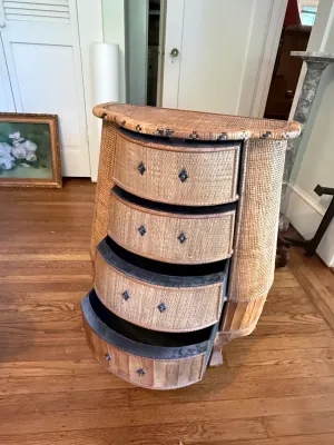 Sale Photo Thumbnail #297: Vintage wicker and wood demi-lune chest of drawers with decorative dark metal hardware and woven details.