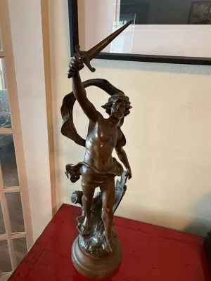 Sale Photo Thumbnail #140: Classical bronze figure sculpture depicting a warrior or mythological hero raising a sword, mounted on a round pedestal base.