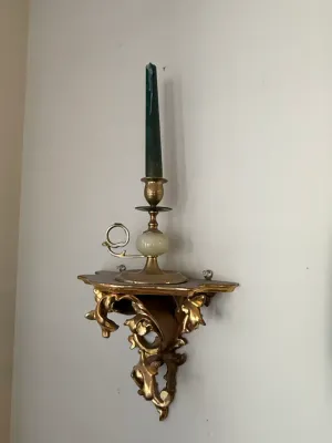 Sale Photo Thumbnail #384: Ornate gilt wall bracket sconce shelf featuring Rococo scrollwork, supporting a brass chamberstick candlestick with an alabaster marble accents.
