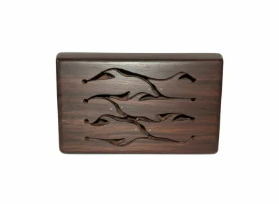 Sale Photo Thumbnail #79: Handcrafted wooden slit tongue drum with carved dolphin-shaped keys, made from rich dark hardwood.