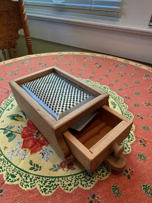 Sale Photo Thumbnail #474: Vintage wooden box grater featuring a metal grating surface and a built-in catch drawer.
