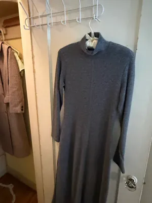 Sale Photo Thumbnail #325: Grey long-sleeved turtleneck knit dress, hanging on a door frame.