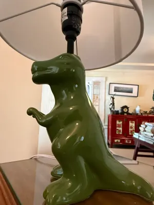 Sale Photo Thumbnail #273: Novelty glazed green ceramic Tyrannosaurus rex table lamp with white fabric shade.
