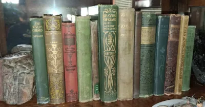 Sale Photo Thumbnail #30: Collection of antique clothbound books, including Whitman's "Leaves of Grass" and Grimm's "Fairy Tales," featuring ornate Art Nouveau spine embossing.