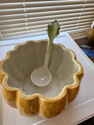 Sale Photo Thumbnail #349: Glazed ceramic pumpkin-shaped punch bowl with matching leaf-handled ladle, in excellent condition.
