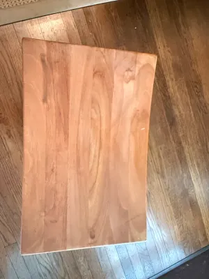 Sale Photo Thumbnail #170: Rectangular light wood stool or side table, viewed from above, featuring visible wood grain and light wear.