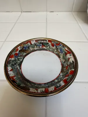 Sale Photo Thumbnail #407: Vintage Japanese Imari porcelain saucer featuring hand-painted floral motifs and a gilt rim.