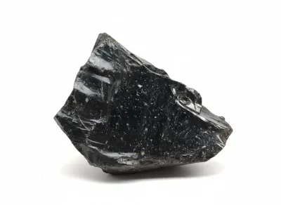 Sale Photo Thumbnail #42: Raw piece of black obsidian crystal displaying glossy, conchoidal fractures.