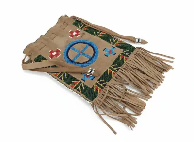 Sale Photo Thumbnail #77: Native American style suede shoulder bag featuring intricate seed beadwork in geometric patterns and long fringe along the bottom edge.