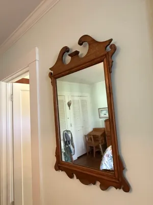 Sale Photo Thumbnail #293: Vintage Chippendale style wood wall mirror featuring a broken arch pediment crown and scrollwork frame.