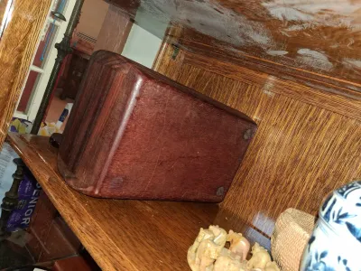 Sale Photo Thumbnail #78: Solid reddish-brown hardwood block or base stored on an oak wooden shelf alongside decorative figurines and ceramics.