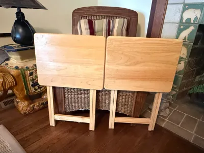 Sale Photo Thumbnail #237: Pair of light natural wood folding TV tray tables in good condition, set in front of a woven armchair.