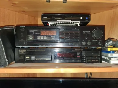Sale Photo Thumbnail #105: Vintage Onkyo TX-82 tuner amplifier stacked above a Pioneer PD-M40 6-disc multi-play CD player, circa late 1980s.