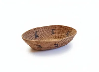 Sale Photo Thumbnail #31: Woven oval fiber basket with dark geometric tribal motif accents.