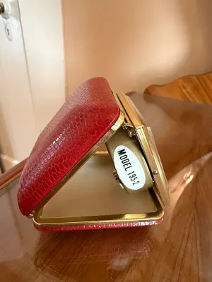 Sale Photo Thumbnail #258: Vintage mid-century travel alarm clock in a red faux-reptile folding clamshell case, labeled Model 195-2.