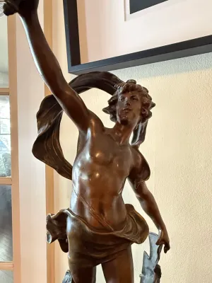 Sale Photo Thumbnail #137: Classical-style bronze sculpture depicting a draped male figure with raised arm.