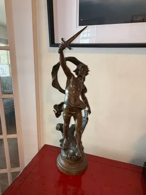 Sale Photo Thumbnail #139: Classical bronze statue of a male figure raising a dagger, mounted on a round wooden base.